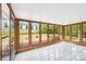 Screened in sunroom featuring large windows and light-colored tile flooring at 6501 Thamesmead Ln, Mint Hill, NC 28227