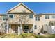 View of the back of the house, featuring a patio with outdoor seating and a well-maintained lawn at 7426 Calhoun Falls Dr, Rock Hill, SC 29732