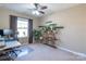 Bright bedroom with a ceiling fan, plant stand, and a large window that provides natural light at 7426 Calhoun Falls Dr, Rock Hill, SC 29732