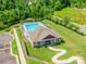 Aerial view of a community pool with lounge chairs and a clubhouse surrounded by lush greenery at 7426 Calhoun Falls Dr, Rock Hill, SC 29732