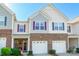 Charming two-story townhouse featuring brick accents, a one-car garage, and a welcoming front porch at 7426 Calhoun Falls Dr, Rock Hill, SC 29732