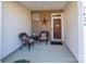 Inviting covered porch with brick walls, two chairs, and a small table perfect for relaxing at 7426 Calhoun Falls Dr, Rock Hill, SC 29732