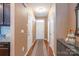Hallway with hardwood floors, neutral paint, and multiple doorways, creating a welcoming entry space at 7426 Calhoun Falls Dr, Rock Hill, SC 29732