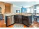 Stylish kitchen featuring dark cabinetry, stainless steel appliances, and an open layout to the living area at 7426 Calhoun Falls Dr, Rock Hill, SC 29732