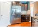 Well-lit kitchen featuring stainless steel refrigerator, granite countertops, and dark cabinetry at 7426 Calhoun Falls Dr, Rock Hill, SC 29732