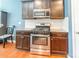Updated kitchen with stainless steel oven, granite countertops, and dark wood cabinets at 7426 Calhoun Falls Dr, Rock Hill, SC 29732
