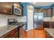 Spacious kitchen with granite countertops, stainless steel appliances, and wooden floors at 7426 Calhoun Falls Dr, Rock Hill, SC 29732