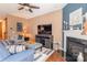 Inviting living room featuring hardwood floors, a fireplace, and comfortable seating with a TV at 7426 Calhoun Falls Dr, Rock Hill, SC 29732