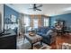Comfortable living space featuring hardwood floors, a blue sofa, and a decorative fireplace at 7426 Calhoun Falls Dr, Rock Hill, SC 29732