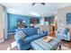 Open-concept living area with a comfortable sofa, hardwood floors, and a glimpse of the kitchen at 7426 Calhoun Falls Dr, Rock Hill, SC 29732
