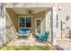 Covered outdoor patio featuring comfortable seating, ceiling fan, and a view of the surrounding yard at 7426 Calhoun Falls Dr, Rock Hill, SC 29732