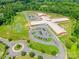 Aerial view of a school with a playground and sports field surrounded by lush greenery at 7426 Calhoun Falls Dr, Rock Hill, SC 29732