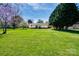 Large grassy backyard displaying mature trees and the exterior of the home at 841 E Zion Church Rd, Shelby, NC 28150