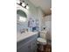 Charming bathroom with a gray vanity, round mirror, and stylish decorative accents at 841 E Zion Church Rd, Shelby, NC 28150
