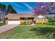 Attractive brick home with an attached garage, complemented by blossoming trees and green lawn at 841 E Zion Church Rd, Shelby, NC 28150