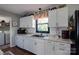 Bright kitchen with white cabinetry and subway tile backsplash, plus modern appliances and a window at 841 E Zion Church Rd, Shelby, NC 28150