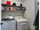 Bright laundry room with washer, dryer, and shelving at 841 E Zion Church Rd, Shelby, NC 28150
