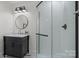 Modern bathroom features a glass shower, a round mirror, and sleek fixtures at 845 2Nd Nw St, Hickory, NC 28601