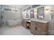 Beautiful bathroom featuring double vanity with marble counters, tub and natural light at 845 2Nd Nw St, Hickory, NC 28601