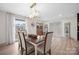 Bright dining room featuring stylish light fixture, wood floors, and a view of the outdoors at 845 2Nd Nw St, Hickory, NC 28601