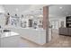 Stylish kitchen featuring a central island with seating, white cabinetry, and a brick accent wall adding character at 845 2Nd Nw St, Hickory, NC 28601
