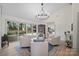 Bright living room with vaulted ceiling, modern chandelier, and backyard view through glass doors at 845 2Nd Nw St, Hickory, NC 28601
