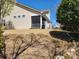 Exterior view of a home featuring a screened-in porch and a tiered, landscaped backyard at 86614 Arrington Rd, Lancaster, SC 29720