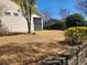 Backyard view showcasing a well-maintained lawn, mature trees, and a screened-in porch at 86614 Arrington Rd, Lancaster, SC 29720