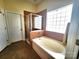 Neutral-toned bathroom features shower, tub, and unique frosted-glass window for privacy at 86614 Arrington Rd, Lancaster, SC 29720
