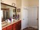 Bathroom with double sink vanity, framed mirror, and tiled flooring at 86614 Arrington Rd, Lancaster, SC 29720