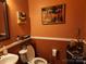Half bathroom features a decorative orange paint and accent pieces at 86614 Arrington Rd, Lancaster, SC 29720