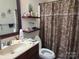 Bathroom featuring a single sink vanity, a framed mirror and a decorative shower curtain at 86614 Arrington Rd, Lancaster, SC 29720