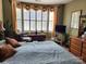 Comfortable primary bedroom with a bay window and a cozy sitting area for relaxation at 86614 Arrington Rd, Lancaster, SC 29720