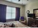 Bedroom featuring a window with blinds and decorative brown curtains allowing natural light at 86614 Arrington Rd, Lancaster, SC 29720
