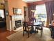 Warm dining space featuring a fireplace, traditional décor, and stylish window treatment at 86614 Arrington Rd, Lancaster, SC 29720