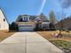 Beautiful home with a manicured lawn, stone details, and a spacious driveway at 86614 Arrington Rd, Lancaster, SC 29720