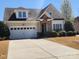 Charming home featuring stone accents, a well-manicured lawn, and a two-car garage at 86614 Arrington Rd, Lancaster, SC 29720