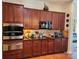 Kitchen featuring cherry cabinets, granite countertops, and modern stainless steel appliances at 86614 Arrington Rd, Lancaster, SC 29720