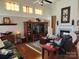 Spacious living room features a fireplace, hardwood floors, and beautiful, colorful windows at 86614 Arrington Rd, Lancaster, SC 29720
