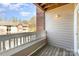 Balcony has wood floors, white railings and views of mature trees and other buildings at 9810 Campus Walk Ln # G, Charlotte, NC 28262