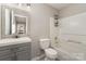 Bathroom featuring a vanity with storage, toilet, and shower-tub combination at 9810 Campus Walk Ln # G, Charlotte, NC 28262