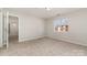 Bright bedroom featuring neutral walls, plush carpet flooring, and a sunlit window at 9810 Campus Walk Ln # G, Charlotte, NC 28262