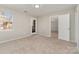 Inviting bedroom featuring plush carpet flooring, neutral walls, natural light, and exterior access at 9810 Campus Walk Ln # G, Charlotte, NC 28262
