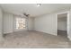 Comfortable bedroom featuring neutral walls, plush carpet flooring, natural light, and a ceiling fan at 9810 Campus Walk Ln # G, Charlotte, NC 28262