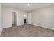 Bedroom features neutral carpet, paint, three entryways and overhead lighting at 9810 Campus Walk Ln # G, Charlotte, NC 28262