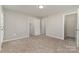 Cozy bedroom featuring plush carpet flooring, neutral walls, multiple closets, and natural light at 9810 Campus Walk Ln # G, Charlotte, NC 28262