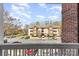 View of building exterior from balcony of nearby building with a parking lot view at 9810 Campus Walk Ln # G, Charlotte, NC 28262