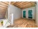 Welcoming entryway with wooden floors, staircase, and green doors leading to units at 9810 Campus Walk Ln # G, Charlotte, NC 28262