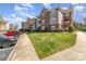 Inviting condo building exterior with lush lawns and convenient parking spaces at 9810 Campus Walk Ln # G, Charlotte, NC 28262