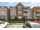 Charming condo exterior with brick accents, multiple balconies, and manicured landscaping at 9810 Campus Walk Ln # G, Charlotte, NC 28262